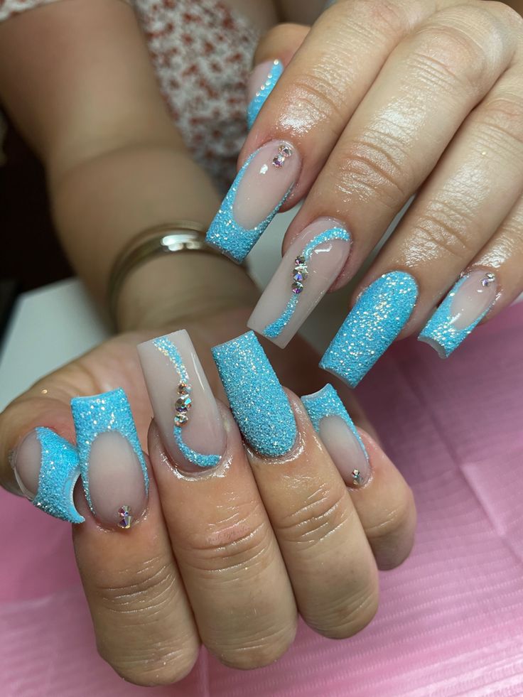 Elegant Sky Blue Nail Design with Glitter Finish and Unique Shape