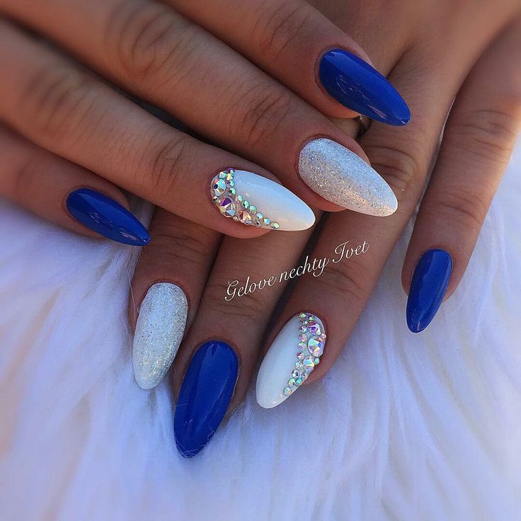 Elegant Stiletto Nail Design: Glossy Blue, Shimmering Silver, and Rhinestone Accents for Glamorous Occasions.