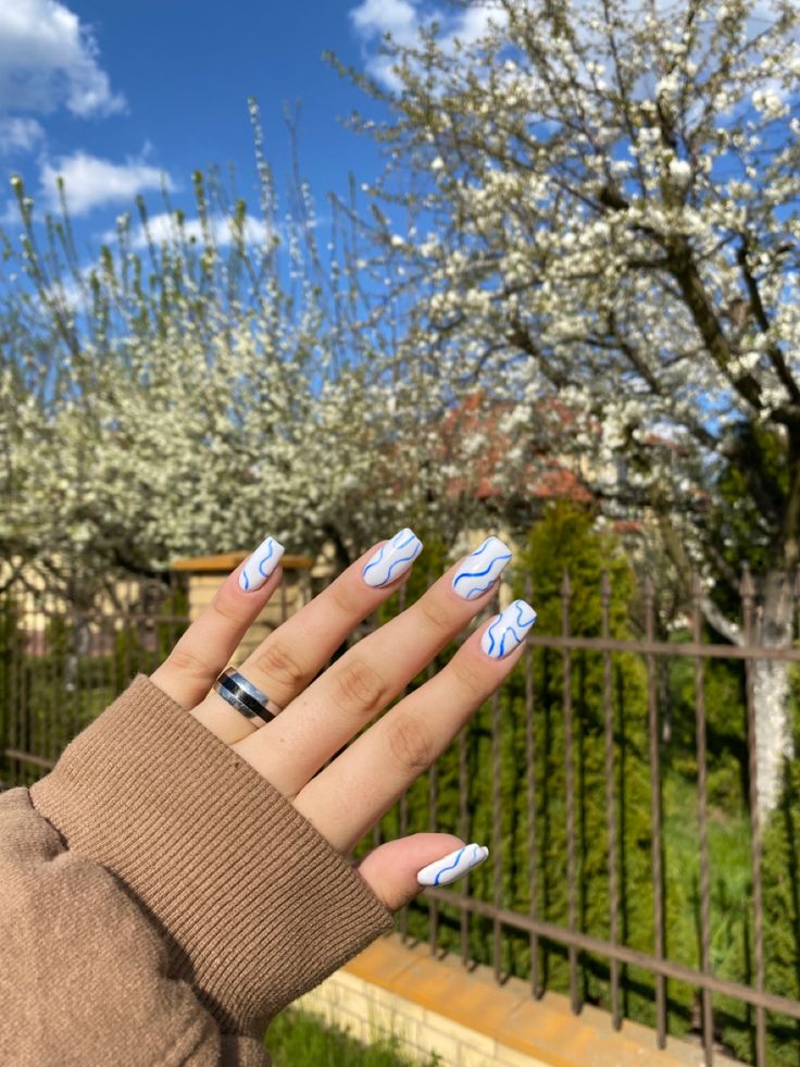 Whimsical Blue-Lined Nail Design for a Trendy Spring Aesthetic.
