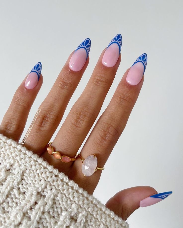 Chic Nail Design: Soft Pink Base with Bright Blue Geometric Tips and Elegant Detailing.