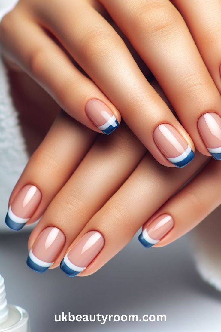 Chic Modern French Manicure with Soft Nude Base and Bold Blue Tips.