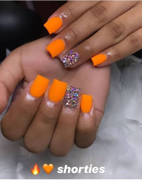 Energetic Orange Matte Nail Design with Glamorous Multicolored Glitter Accent.