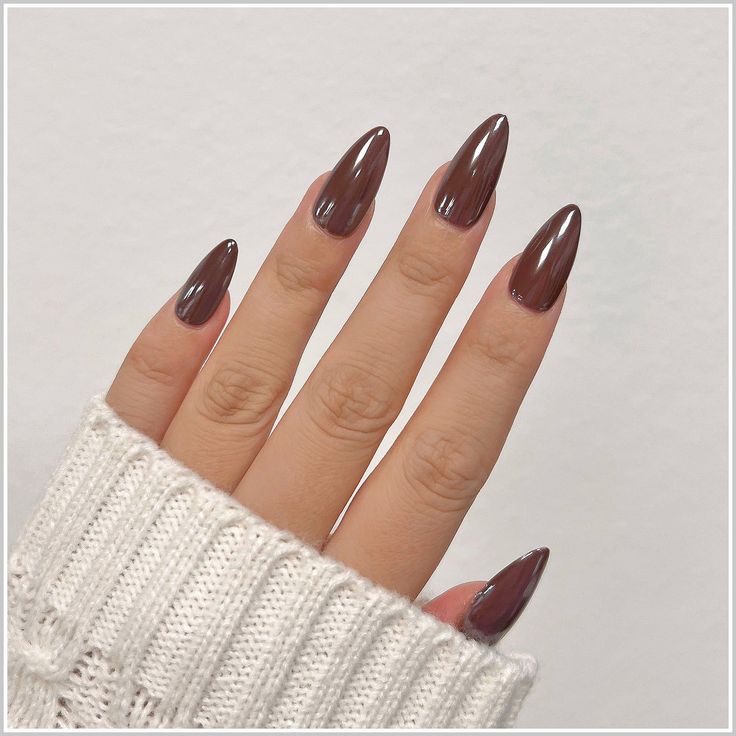 Chic Almond-Shaped Nails in Glossy Chocolate Brown: A Bold and Timeless Trend.