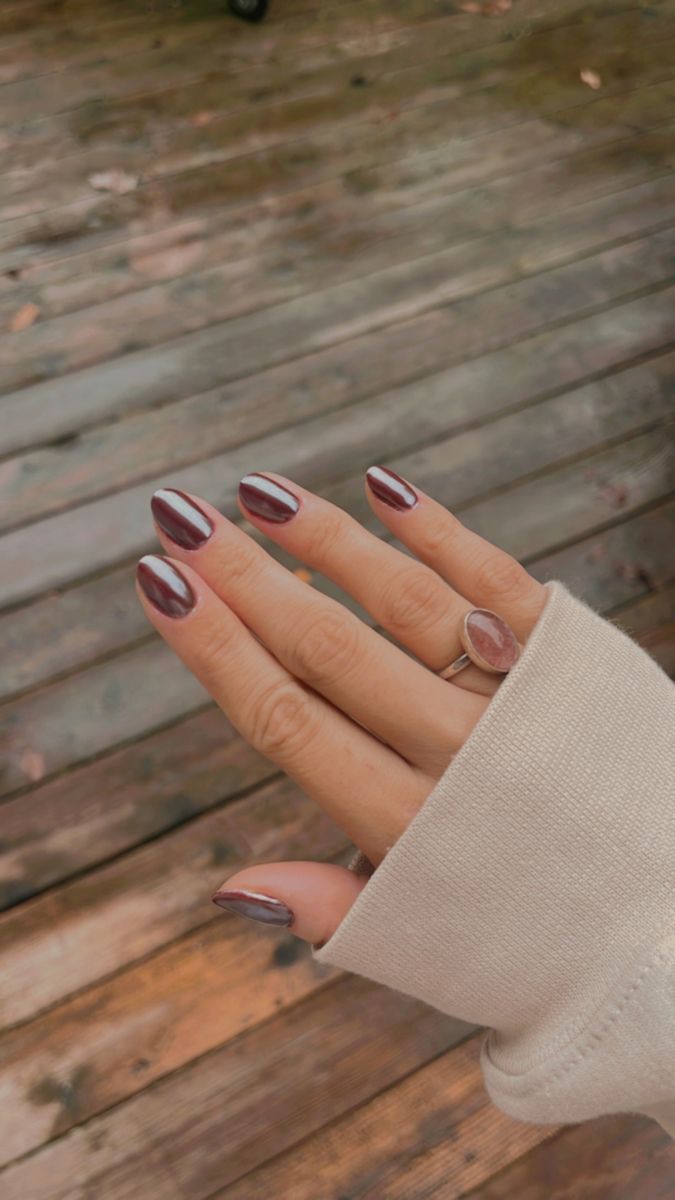 Sophisticated Chic Nail Design: Deep Burgundy with Glossy Silver Stripes