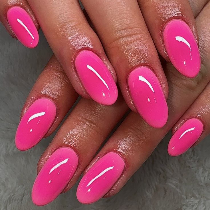 Bold and Playful Vibrant Pink Almond-Shaped Nails for a Fun Manicure.