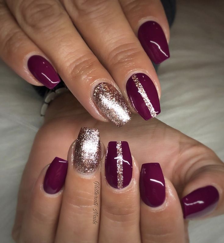 Sophisticated Burgundy and Gold Nail Design with Modern Silver Stripes.