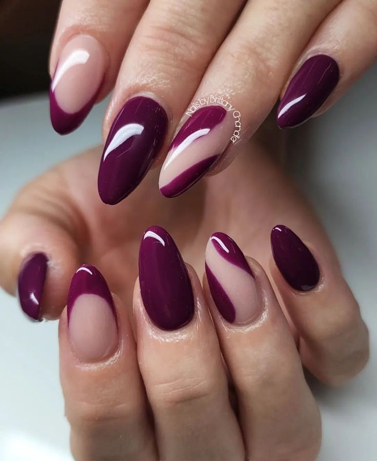 Chic Almond-Shaped Nail Design: Deep Purple and Nude with Modern Geometric Patterns.