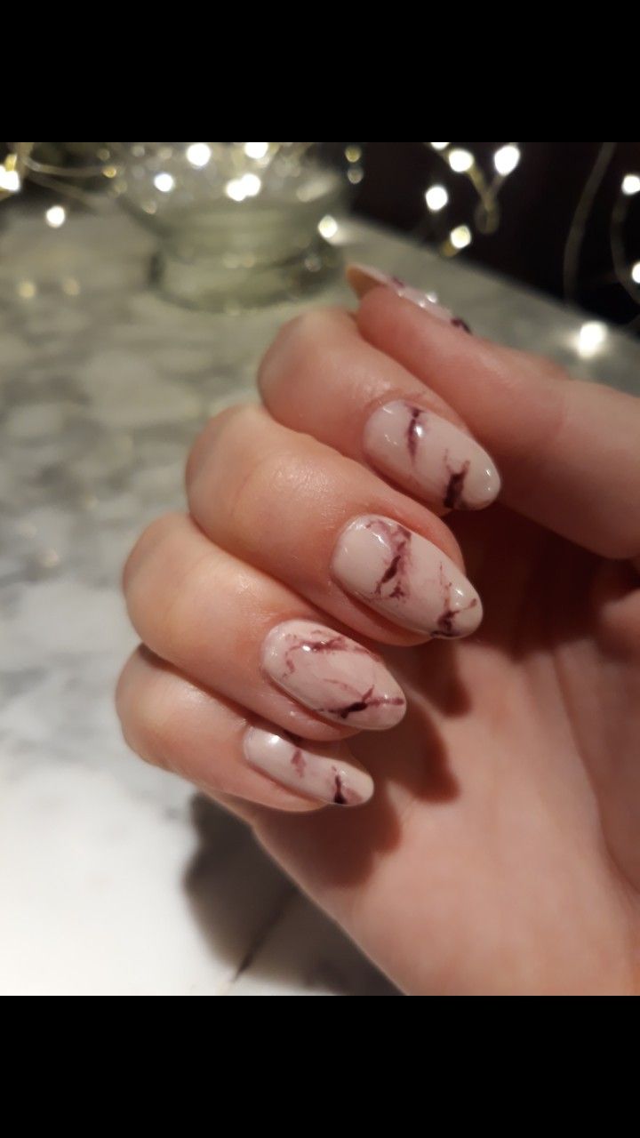 Sophisticated Almond-Shaped Nail Design with Soft Nude Base and Burgundy Marbling.