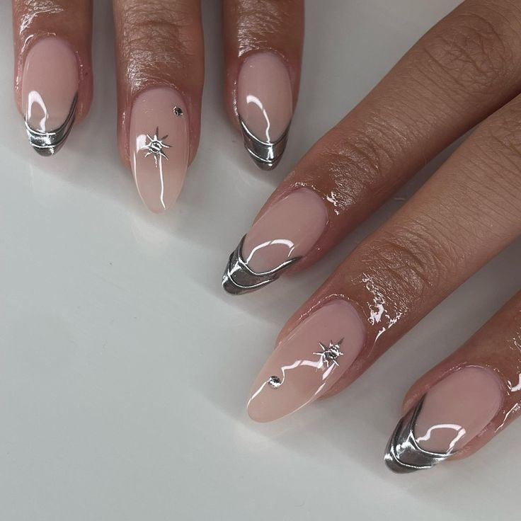 Chic Nude and Metallic Silver Nail Design with Star Motifs and Swirls.