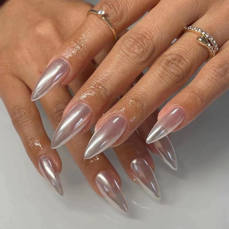 Elegant Stiletto Nails: Glossy Finish and Iridescent Sheen for Sophisticated Style.