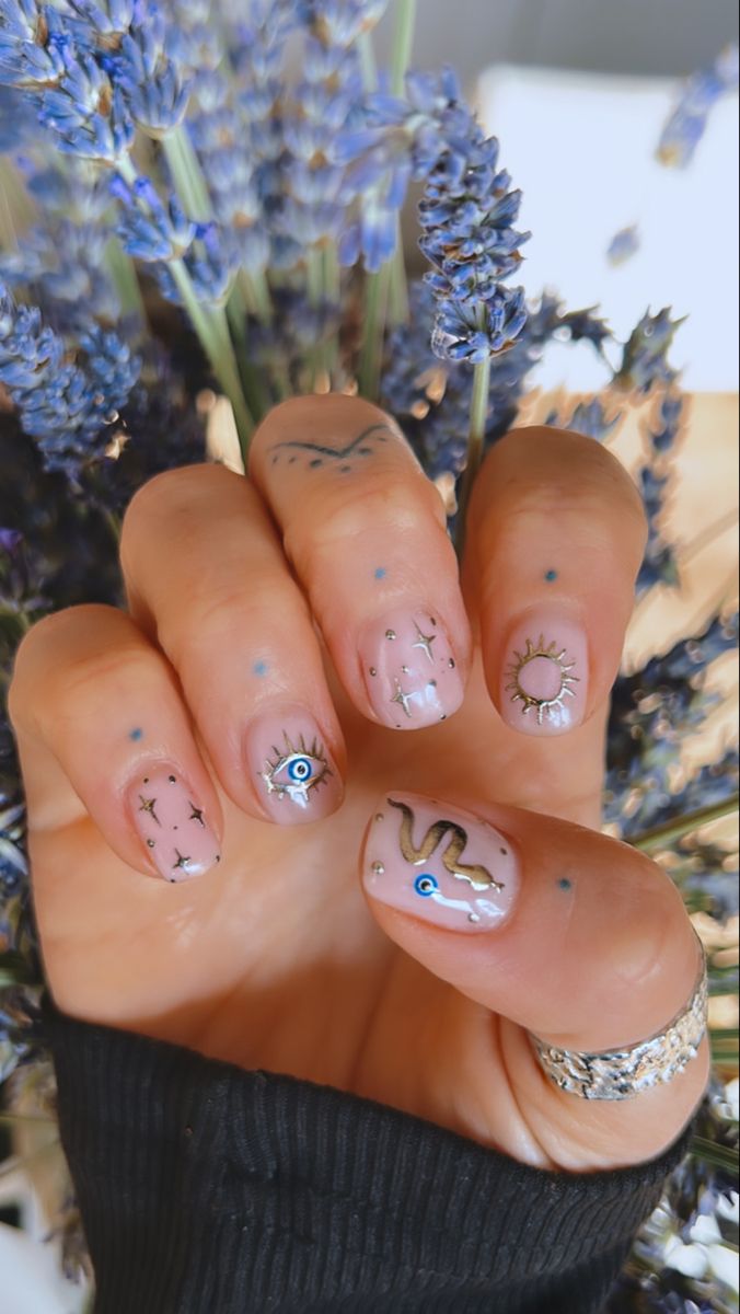 Celestial-Inspired Whimsical Nail Design with Elegant and Playful Patterns.