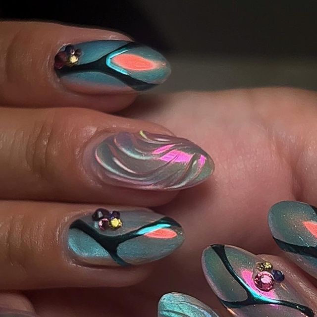 Teal and Iridescent Nail Design with Marbled Swirls and Gem Accents.