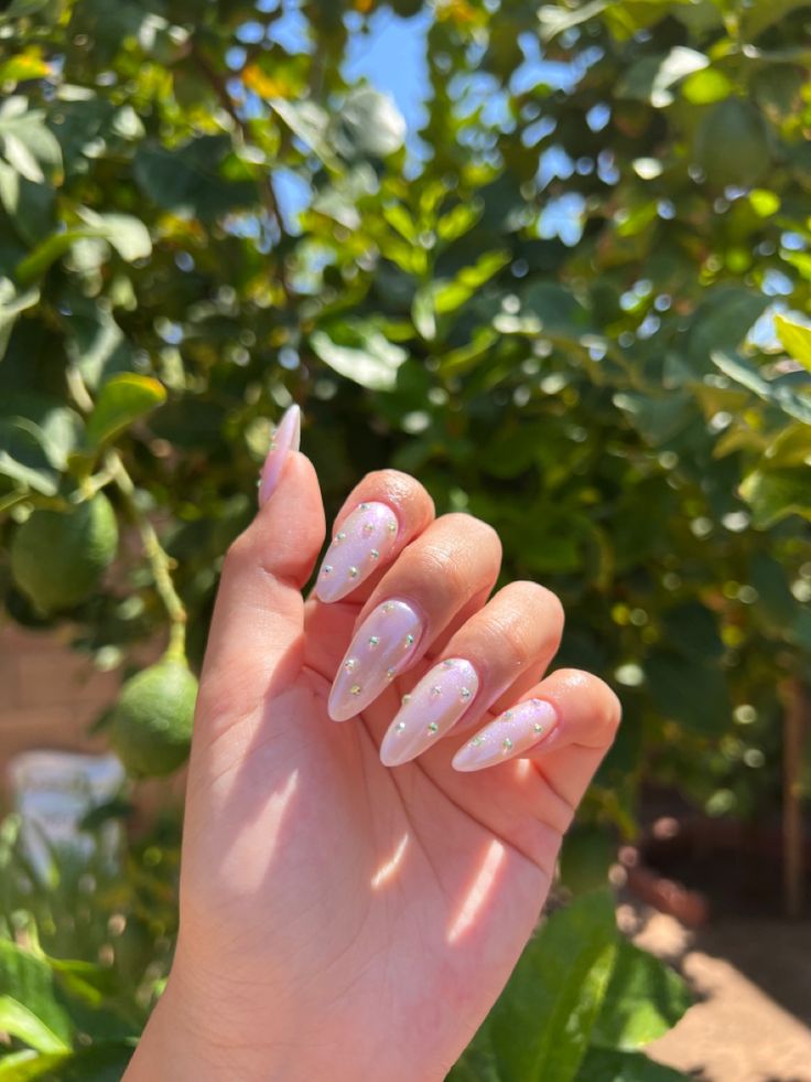 Elegant Almond-Shaped Manicure with Blush Base and Sparkling Gem Accents.