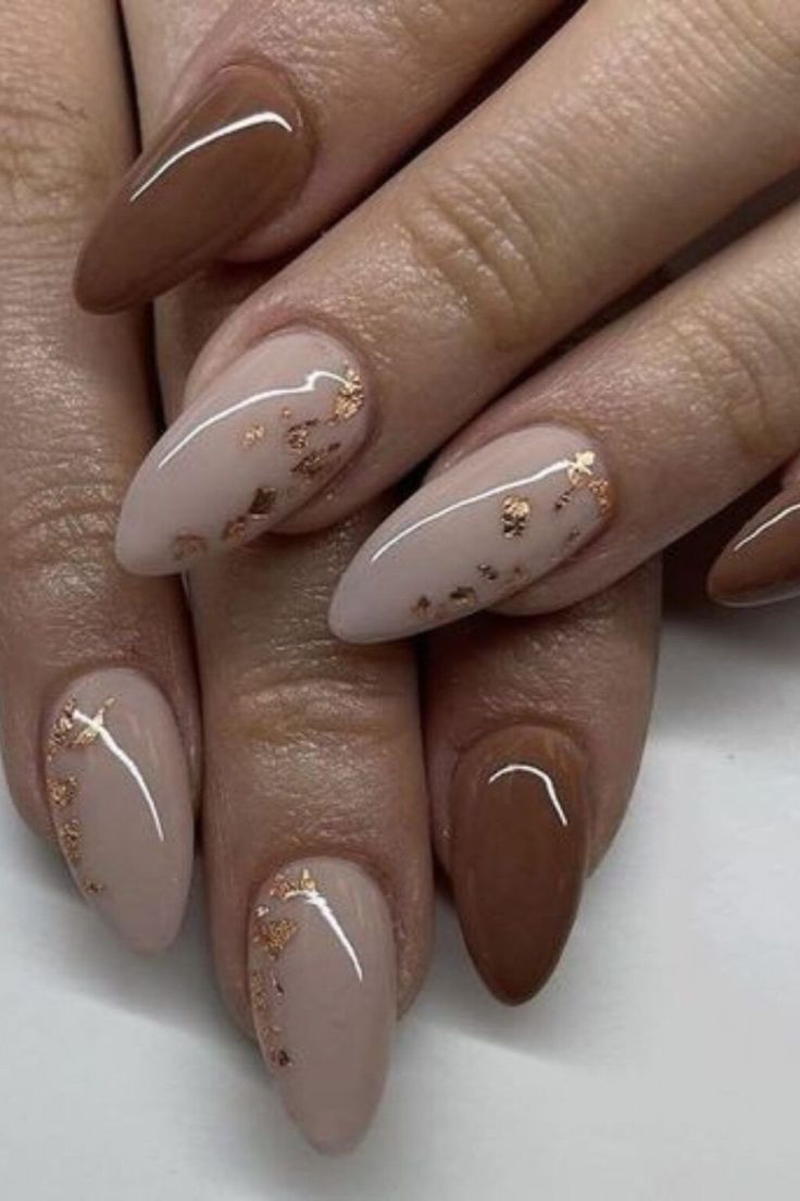 Elegant Neutral and Brown Nail Design with Glossy Finish and Gold Accents.