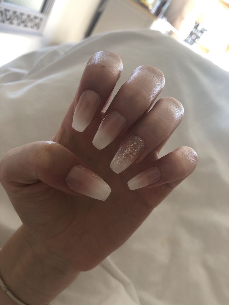 Chic Glossy French Tip Nails with Subtle Nude Base and Glitter Accent.