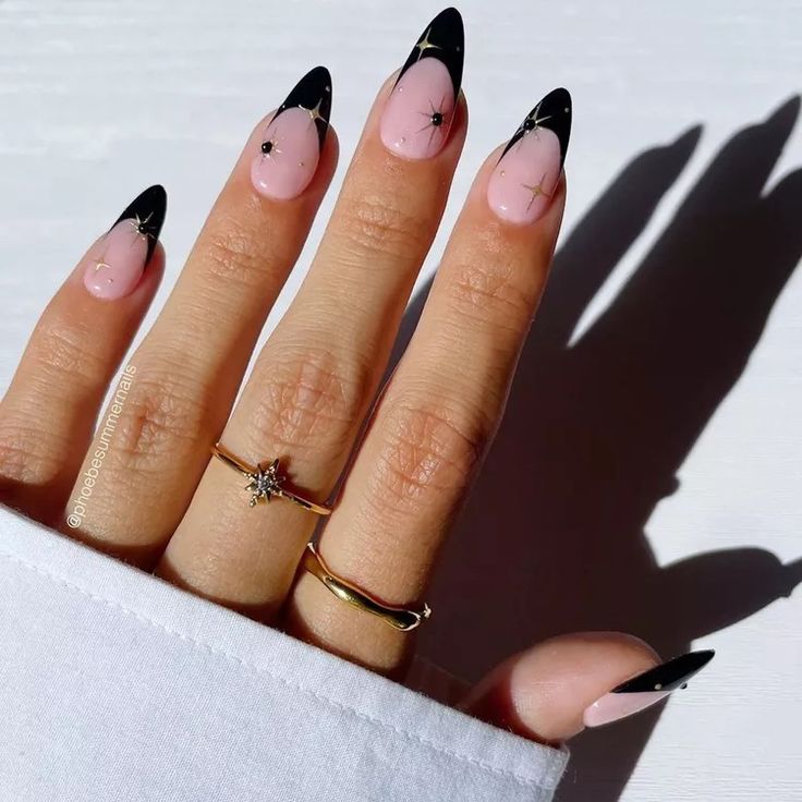 Sophisticated Elegant Nail Design: Glossy Black Elongated Tips on Pastel Pink Base with Delicate Gold Accents.