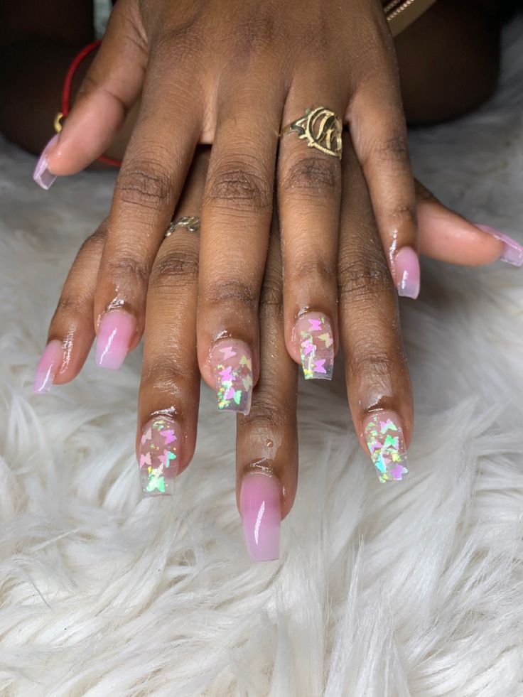 Elegant Soft Pink Nail Design with Holographic Butterfly Accents for a Trendsetting Look.