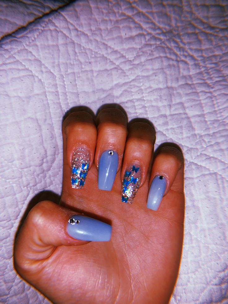 Elegant Light Blue Nail Art with Glitter Accents and Rhinestones