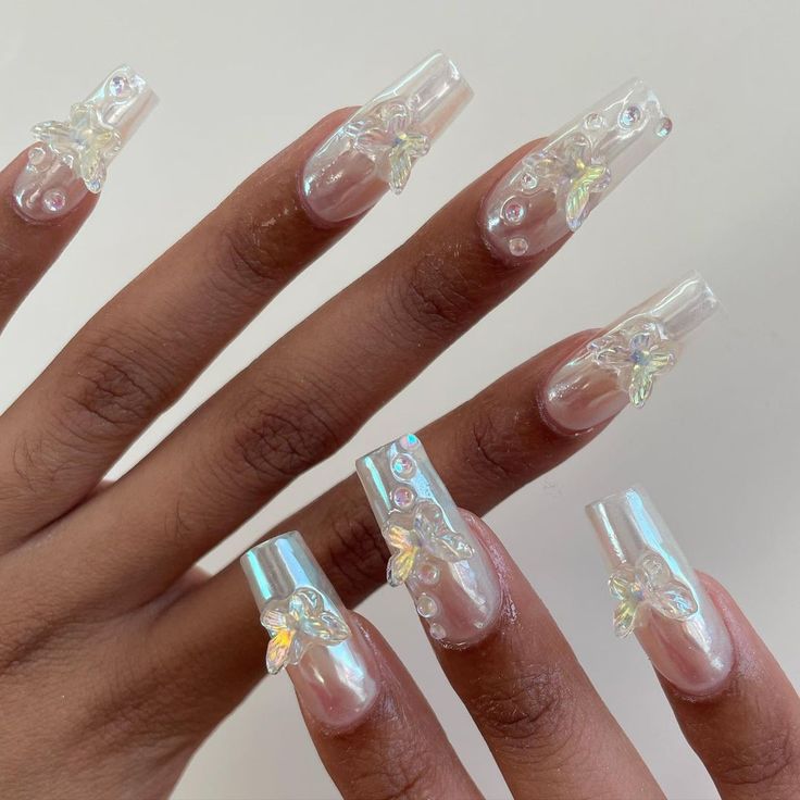 Whimsical Sophistication: Long Clear Acrylic Nails with Iridescent Gems and Floral Embellishments.