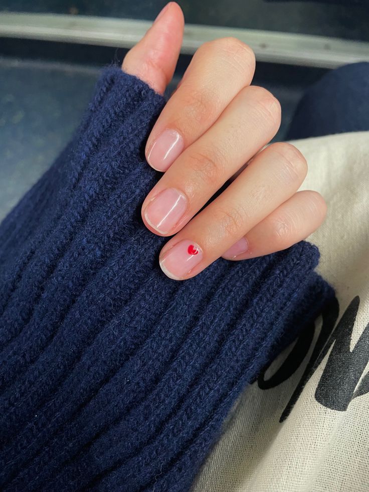 Charming Minimalist Nail Design with Red Heart Accent