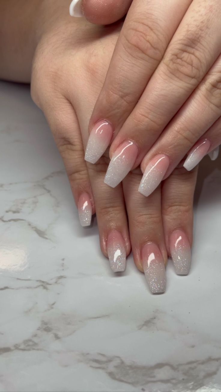 Chic Ombre Nails: A Subtle Blend of Soft Pink and White with Sparkling Tips