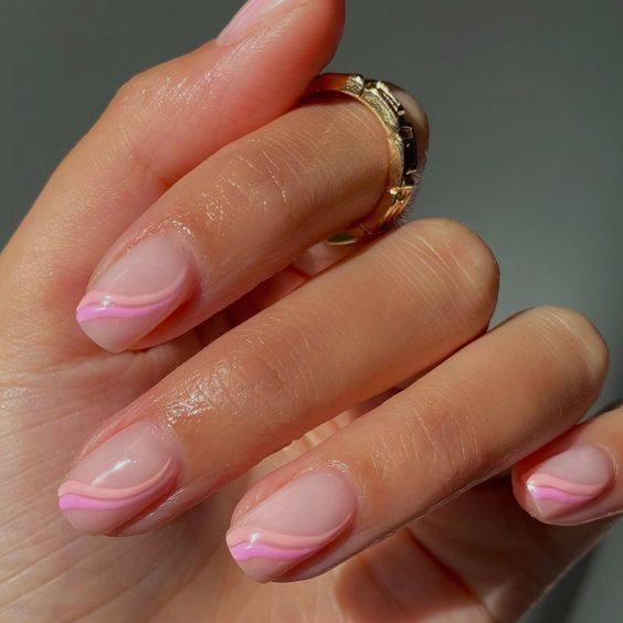 Elegant Minimalist Pink Nail Design with Swirled Pattern.