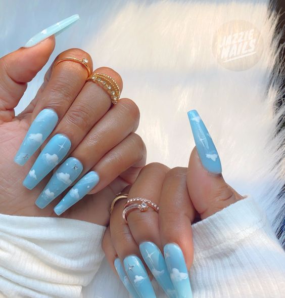 Dreamy Sky-Themed Nail Design: Soft Blue Base with White Clouds and Elegant Metallic Accents