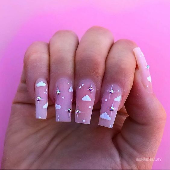 Playful Cloud-Themed Nail Design with Pink Base and Sparkling Accents.