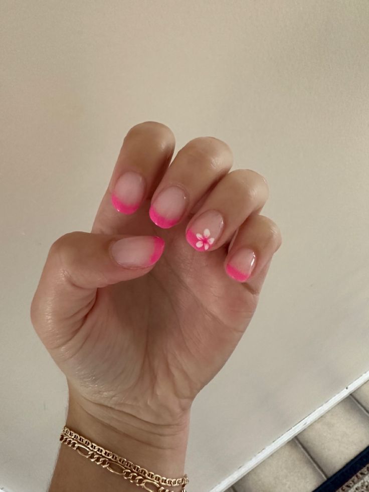 Cheerful Ombre Pink French Tips with Charming Floral Design.