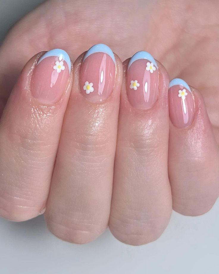 Pastel Floral-Inspired Nail Design: Elegant Soft Pink and Sky-Blue Tips with Charming White Flowers.