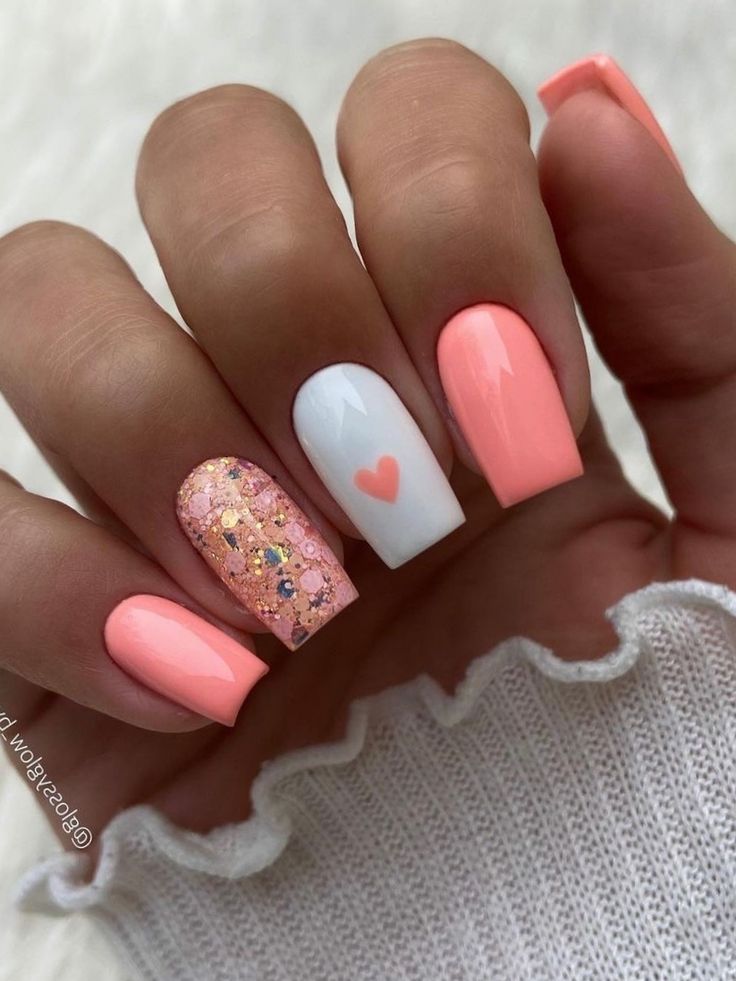 Playful Pastel Nail Design with Glitter and Heart Accents.