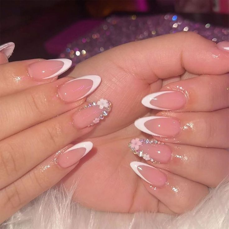 Chic Soft Pink Nail Design with White Tips, Floral Embellishments, and Sparkling Rhinestones