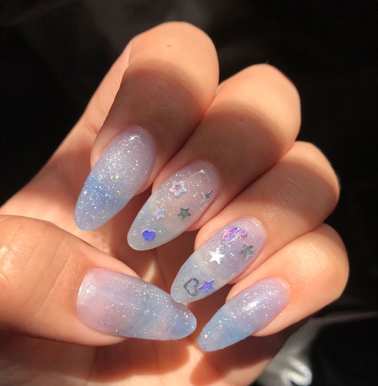 Whimsical Galaxy-Inspired Nail Design with Translucent Ombre and Glitter Accents.