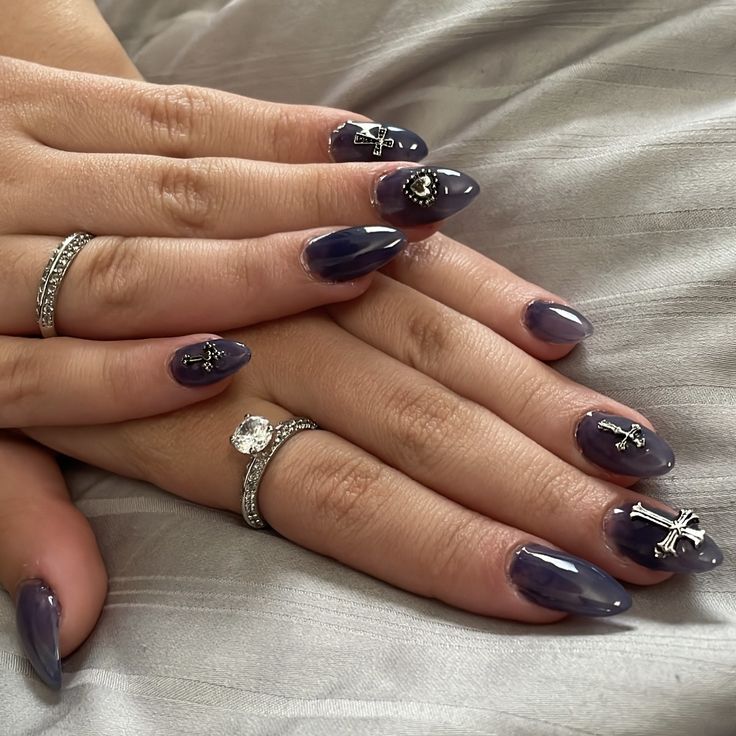 Sophisticated Deep Purple Nail Design with Glossy Finish and Intricate Silver Accents.