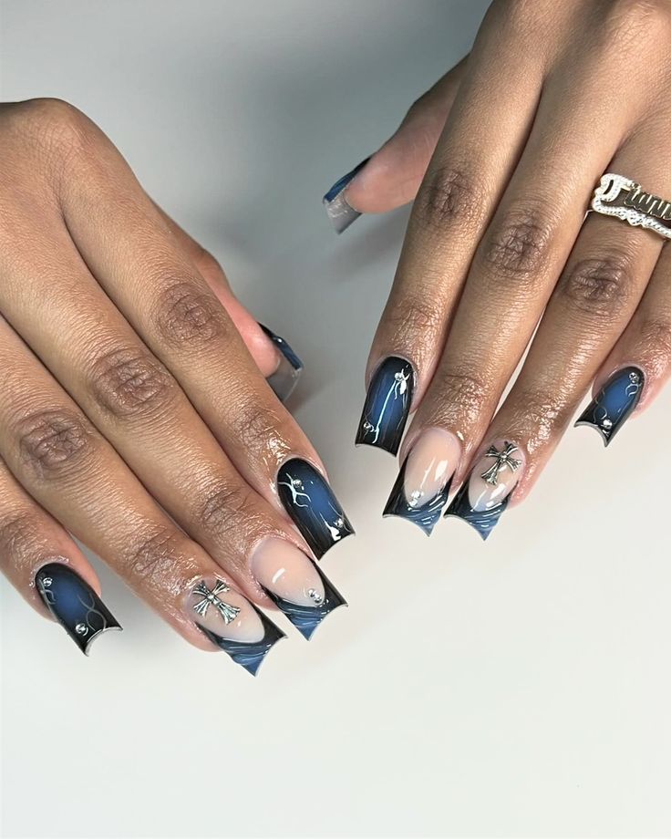 Elegant Stiletto Nail Design with Blue Gradient, Black Tips, and Glamorous Silver Embellishments.