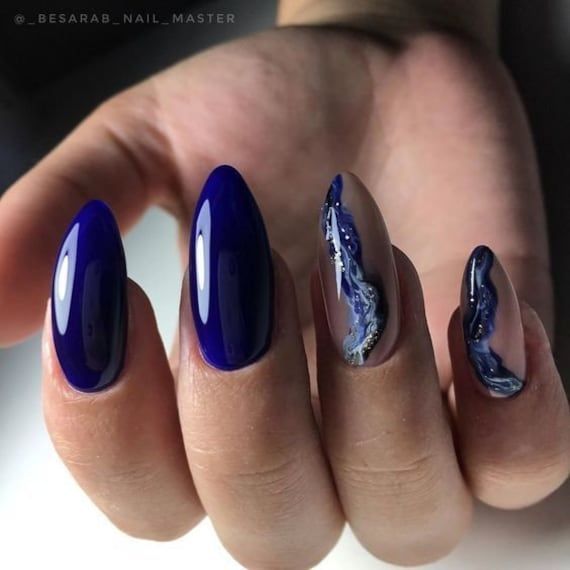 Chic Vibrant Blue Almond Nail Design: Glossy and Marbled Elegance for Any Occasion.