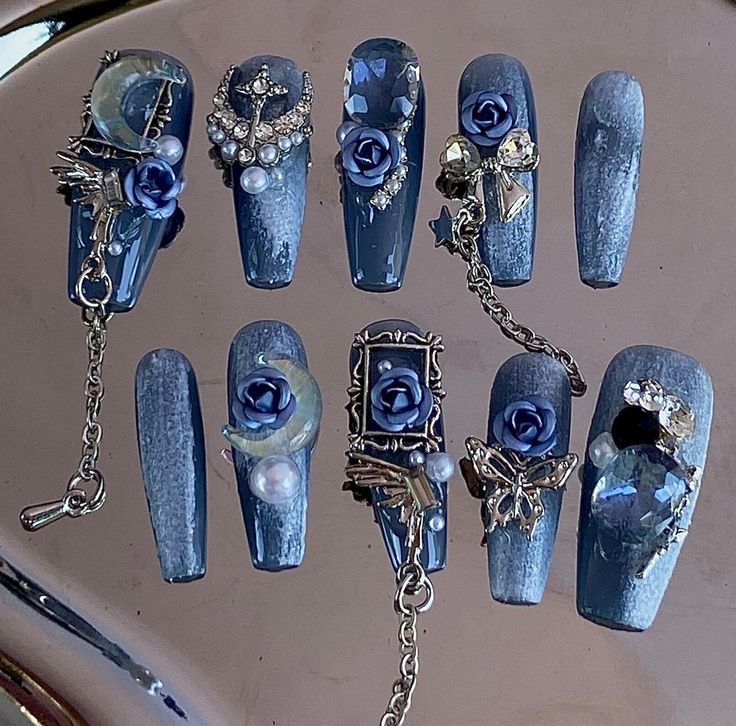 Elegant Deep Blue Nail Design with Roses, Gems, and Unique Charms.