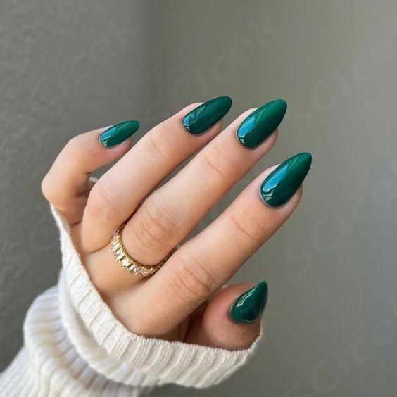 Glamorous Glossy Green Nails with Elegant Design and Gold Accents.