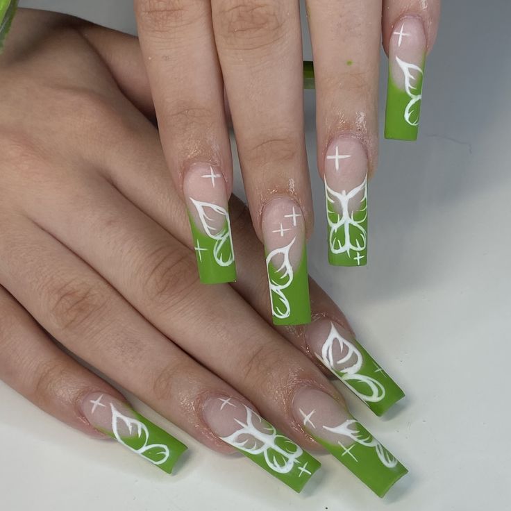 Elegant Matte Green and White Nail Design with Intricate Butterfly Patterns on Long Square Tips.