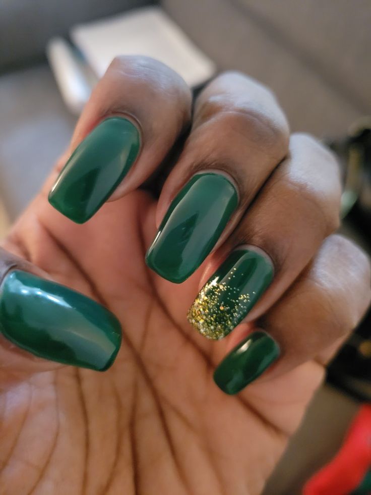 Sophisticated Green Manicure with Glamorous Gold Glitter Accent