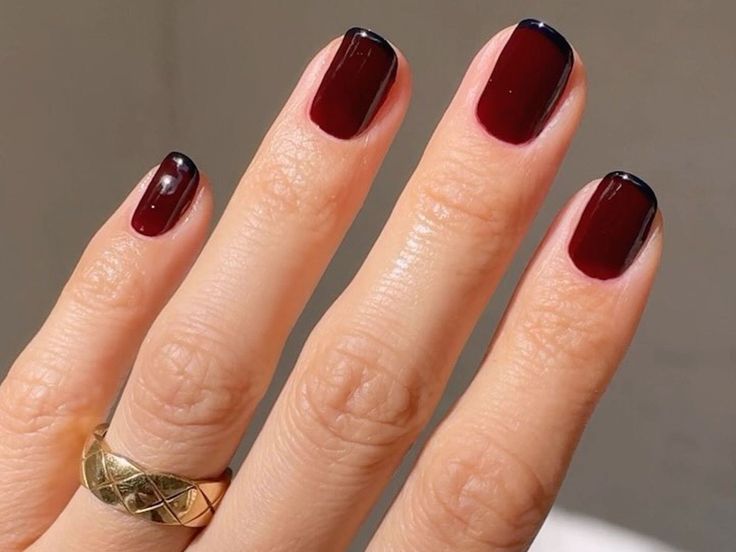 Elegant Burgundy Nails with Sleek Black Tips for a Chic Manicure.