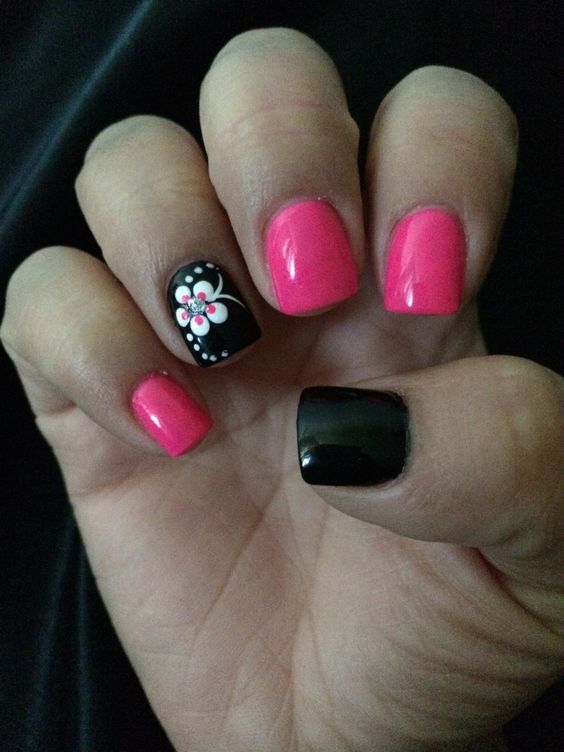 Bold and Playful Vibrant Nail Design with Striking Color Contrast and Floral Art.