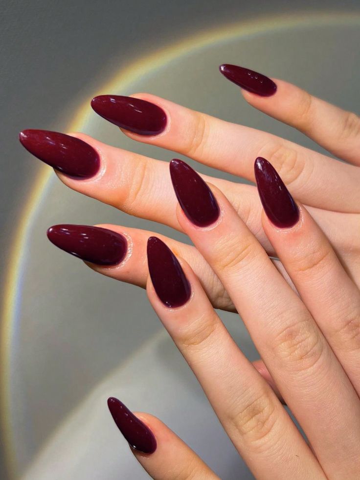 Elegant Almond-Shaped Burgundy Nails with Glossy Finish for a Chic Look.