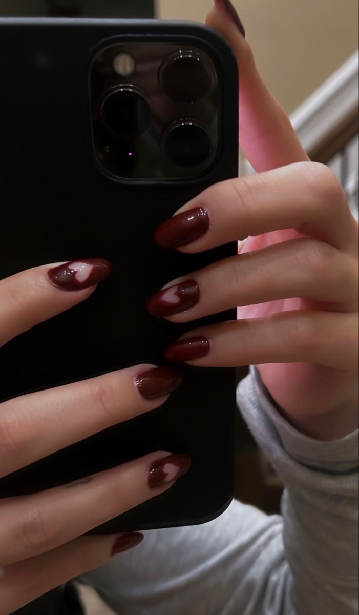 Charming Maroon Nail Design with Heart Accents for a Romantic Touch.