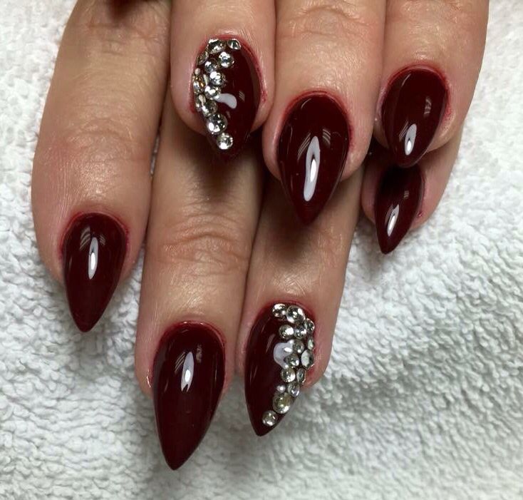 Glamorous Burgundy Stiletto Nails with Glossy Finish and Rhinestone Accents