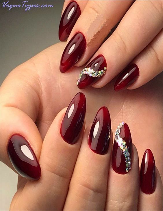 Sophisticated Red Almond-Shaped Nails with Shimmering Rhinestone Accent.