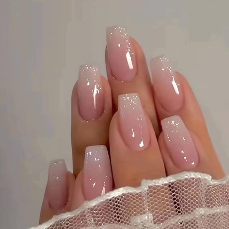 Chic Ombre Nail Design: Soft Pink Gradient with Glossy Finish and Sparkle Accents