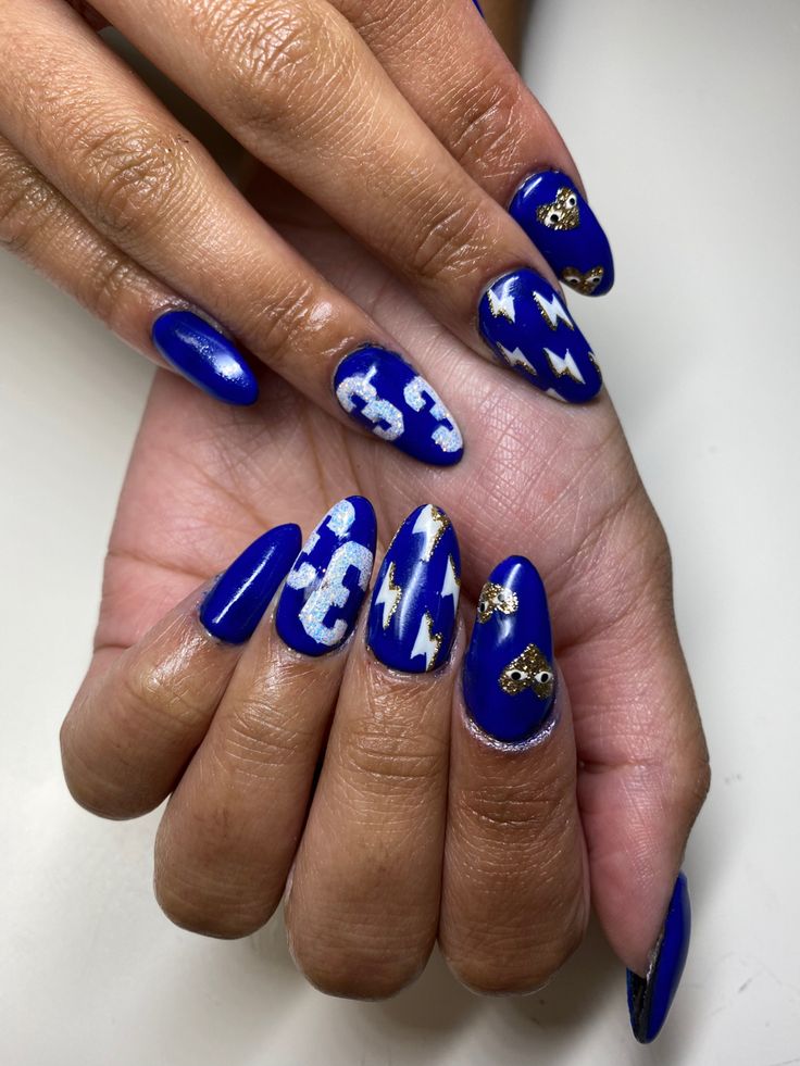 Sophisticated Vibrant Blue Nail Art with Glossy and Matte Finishes, Striking Designs, and Elegant Gold Accents.