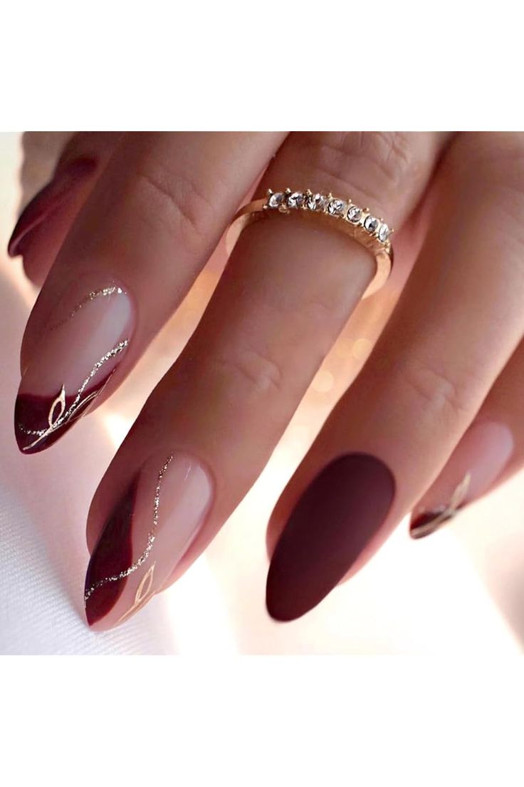 Elegant Almond-Shaped Nail Design in Deep Burgundy and Nude with Matte Finish and Golden Accents.