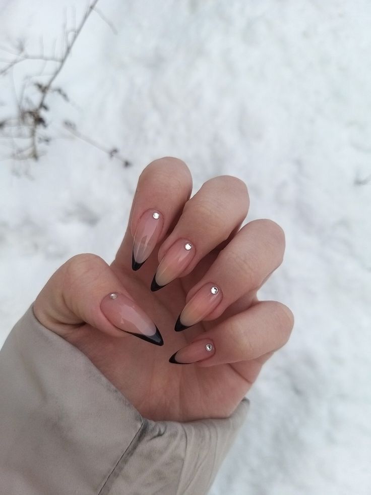 Chic Almond-Shaped Nails: Nude Ombre with Glossy Black Tips and Rhinestones